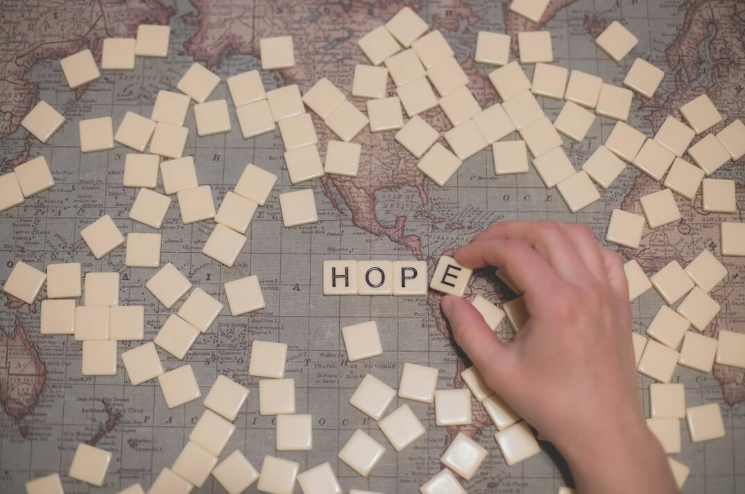 Close-up of hands arranging sticky notes on a journey map